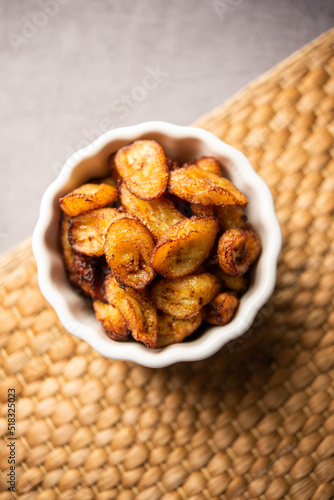 Deep fried ripe plantain slices or pake kele fried chips in a bowl