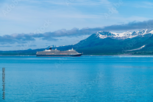 A view across Disenchartment Bay towards a cruise ship in Alaska in summertime