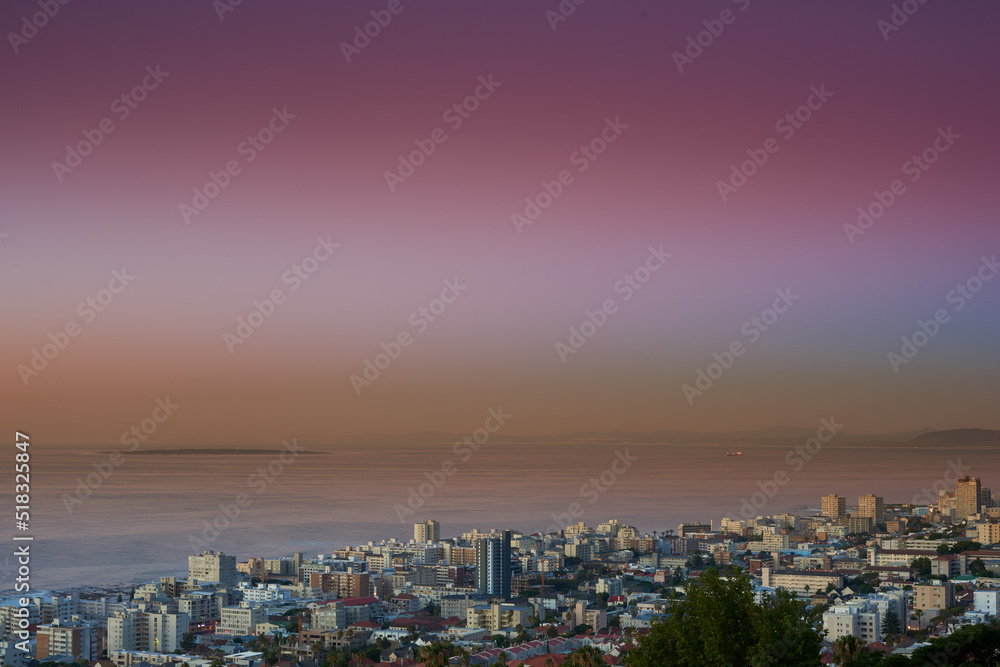 Copy space sunset sky and city view of building infrastructure with sea or ocean background in abroad travel destination. Aerial of Cape Town downtown centre and urban cityscape architecture at night