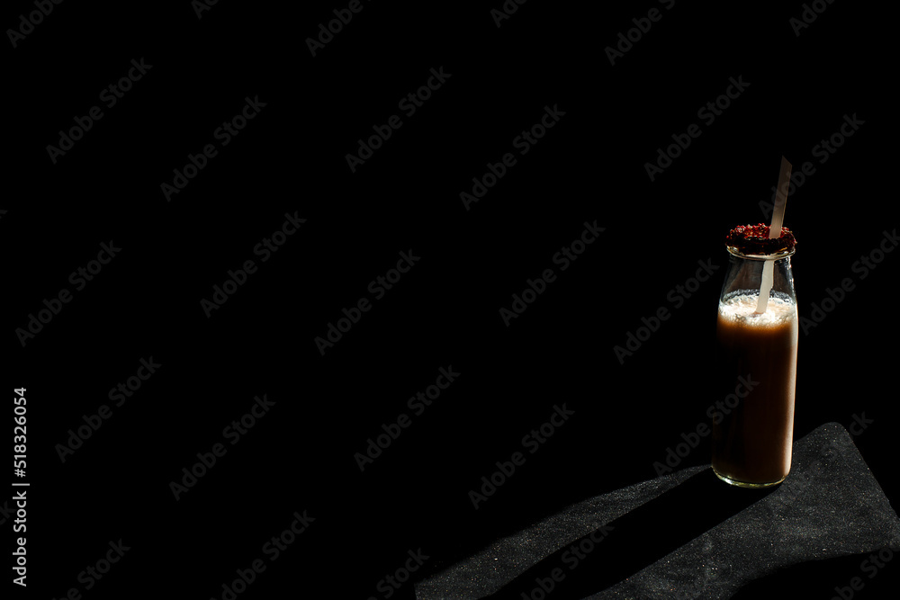 Obraz premium Coffee bottle isolated black background.