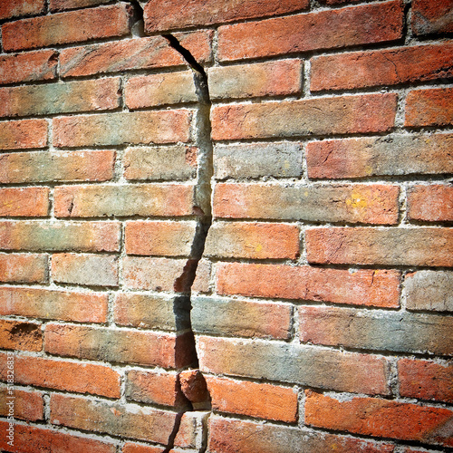 Old cracked brick wall - wall built in the 16th century