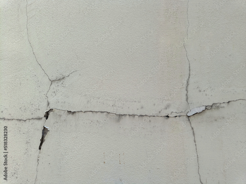 Fototapeta premium Broken cracked damaged cement wall surface in need of repair old texture background. affected by the earthquake