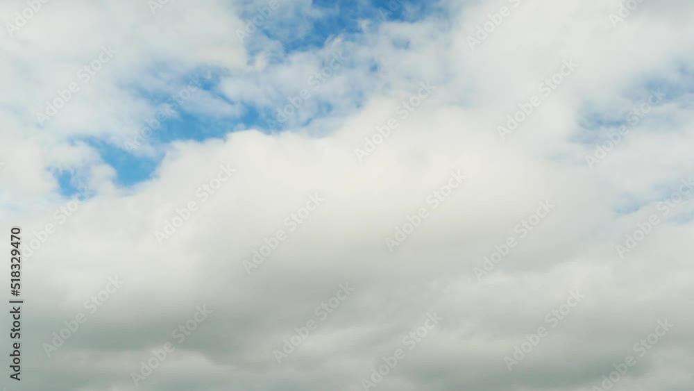 White rain clouds float across the blue sky, time lapse White rain clouds float across the blue sky, time lapse