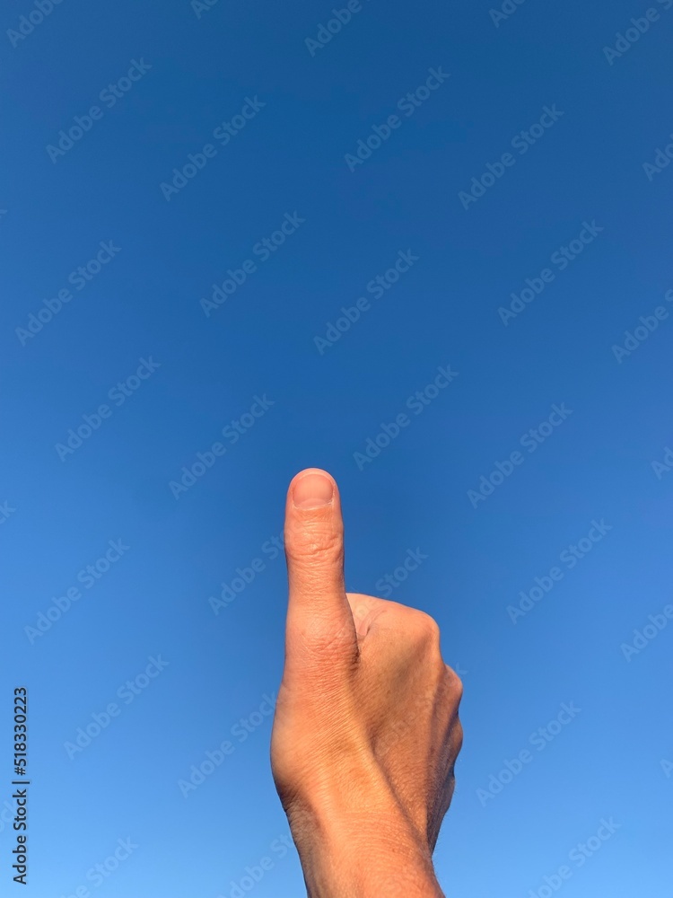 Thumb up to the sky with lots of copy space Thumb up to the sky with lots of copy space