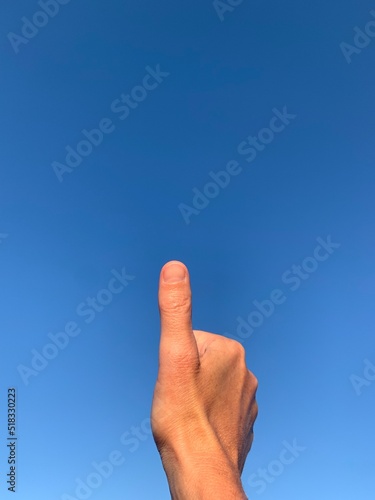 Thumb up to the sky with lots of copy space