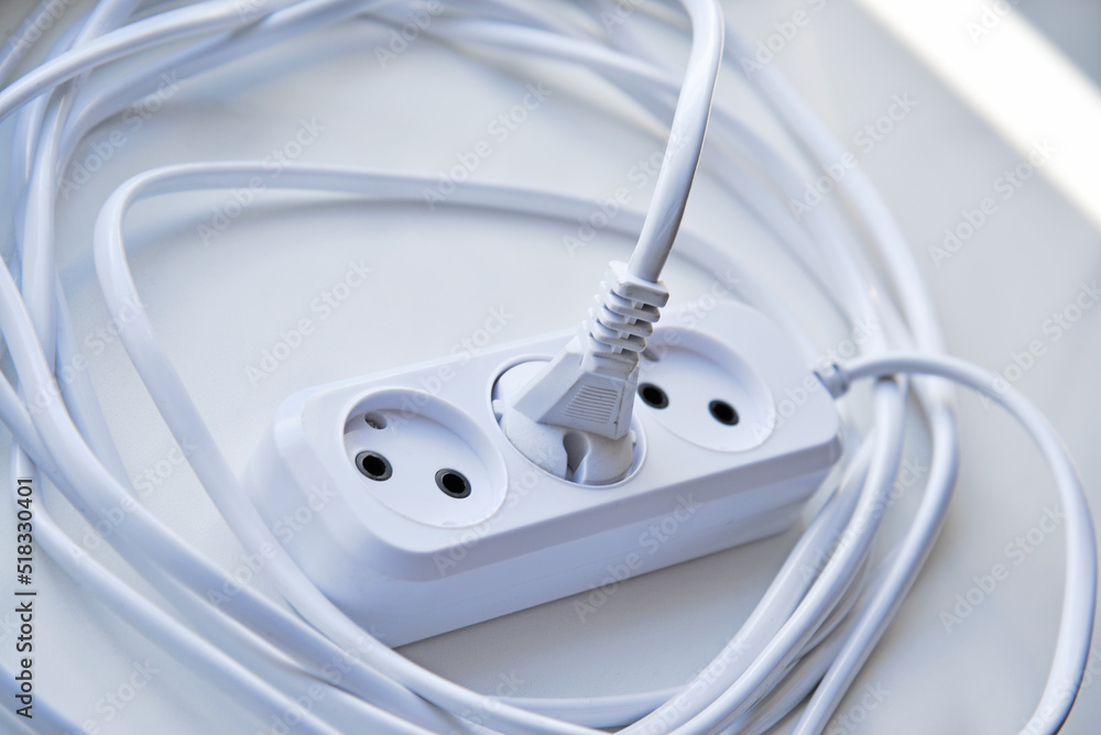 White electric extension cord, great design for any purposes. White background. White electric extension cord, great design for any purposes. White background.