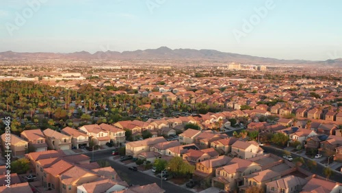 Aerial scenic shot of Las Vegas suburbs during golden hour with mountains