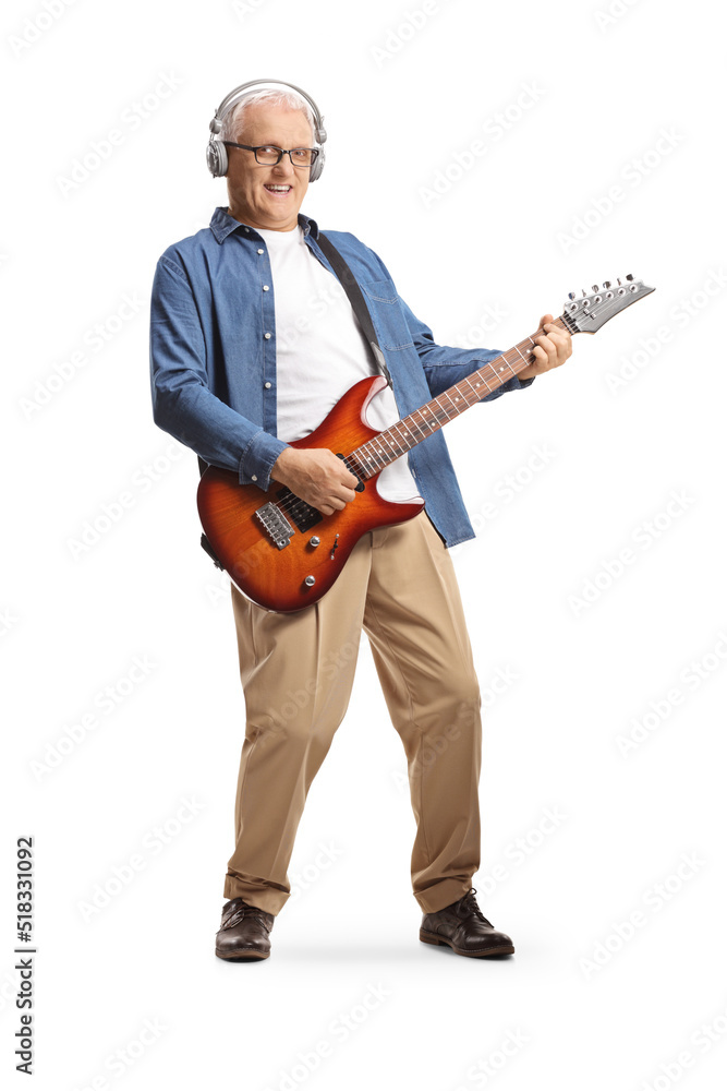 Full length portrait of a mature man with headphones and electric guitar Full length portrait of a mature man with headphones and electric guitar