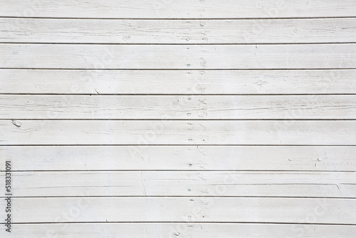 Old weathered white painted wooden slatted wall