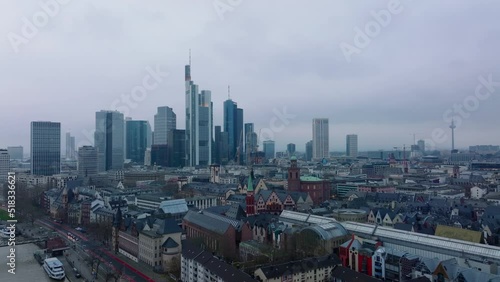 Fly over historic city centre. Cityscape with group of modern high rise office buildings on cloudy day. Frankfurt am Main, Germany photo