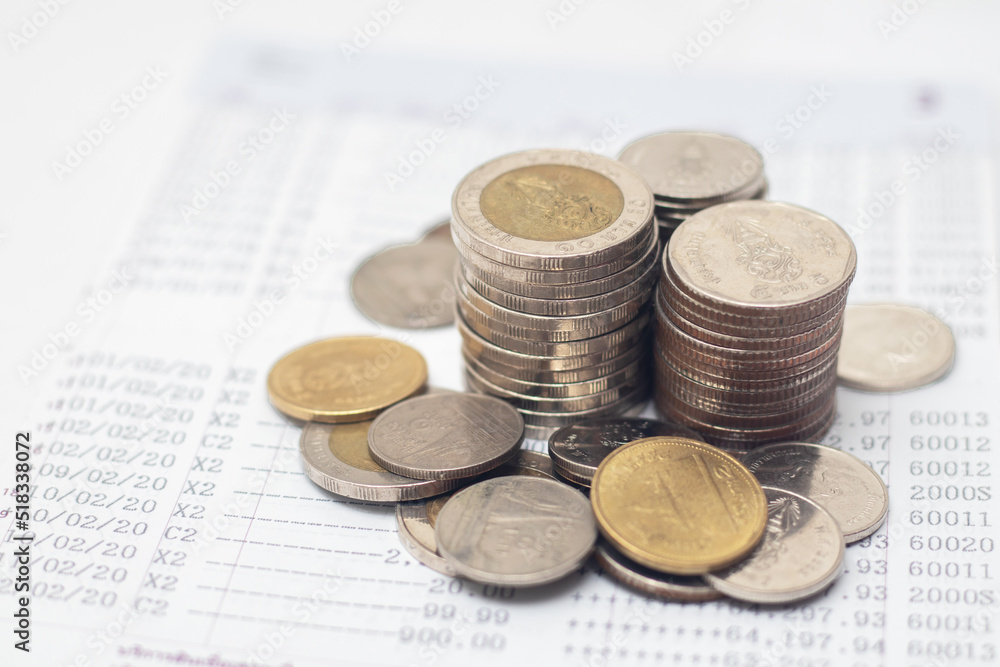 Coins are placed on the account book. money saving concept Coins are placed on the account book. money saving concept