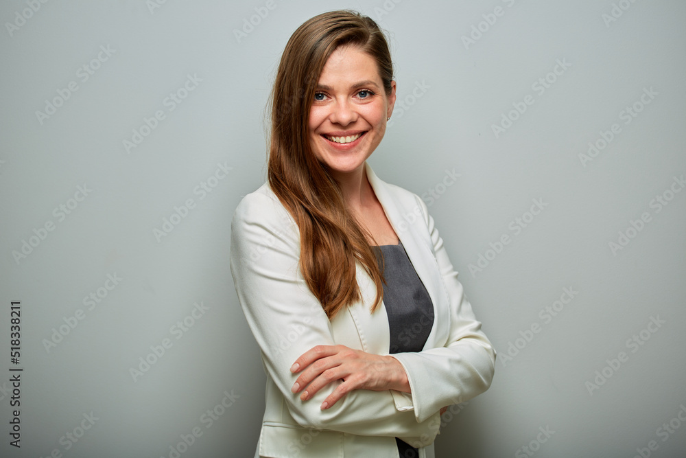 Smiling business woman in white suit standing with arms crossed, isolated portrait. Smiling business woman in white suit standing with arms crossed, isolated portrait.