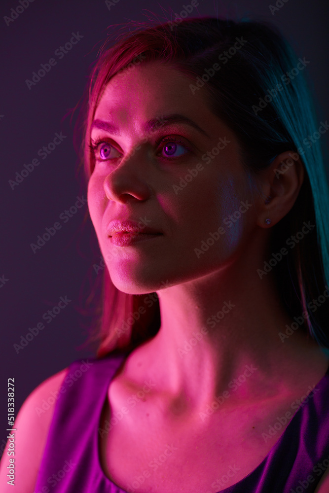 Futuristic look woman with red light, looking away, female face beauty portrait with colored light. natural skin. Futuristic look woman with red light, looking away, female face beauty portrait with colored light. natural skin.