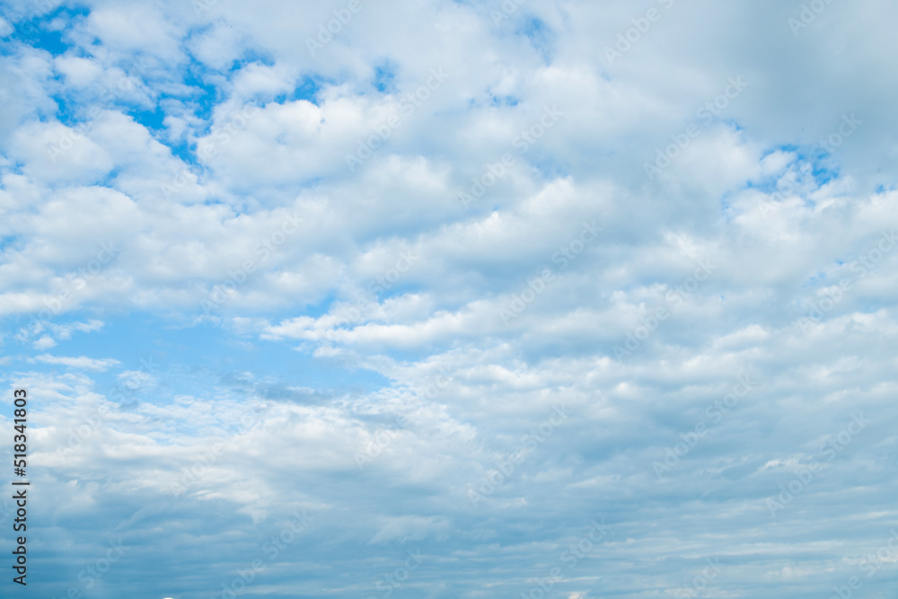 cloudy blue sky with white fluffy clouds. background