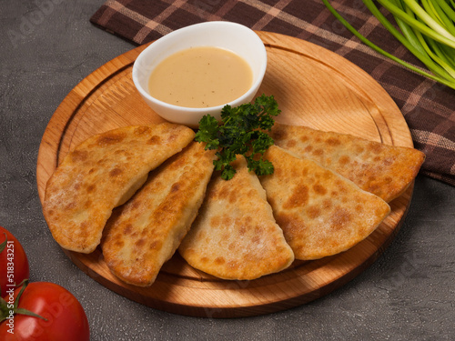 posikunchiki with mustard sauce on a wooden board photo