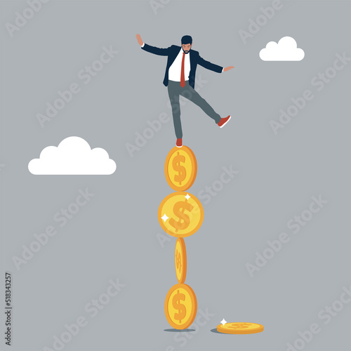 Investor falling from stack of unstable money coins. Unstable investment market, risky situation or economic recession, crisis or bankruptcy. photo