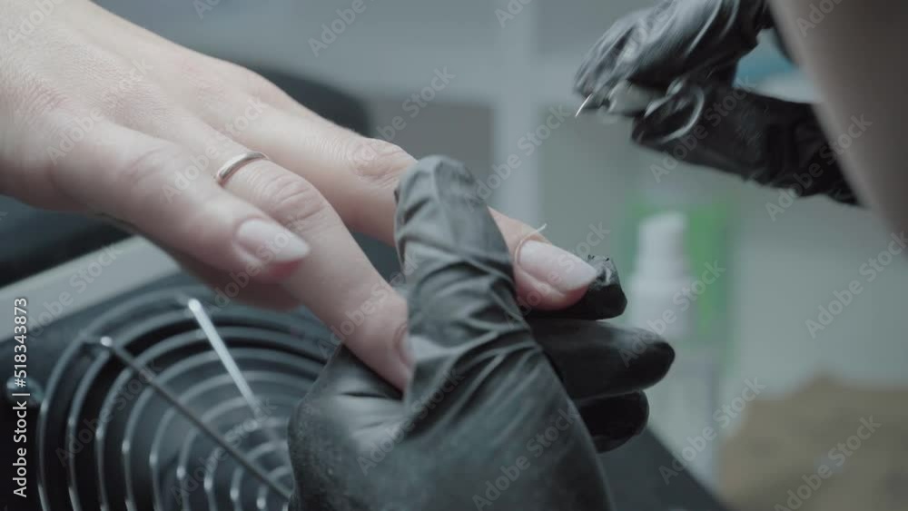 The process of manicure in a beauty salon close-up. Cuticle removal The process of manicure in a beauty salon close-up. Cuticle removal