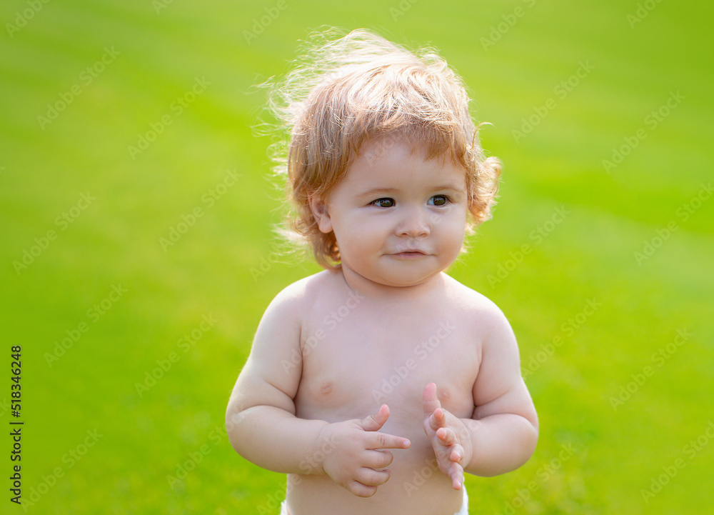 Happy baby in grass on the fieald at sunny summer evening. Smiling child outdoors. Funny little child closeup portrait. Kids emotion, happy smiling face. Happy baby in grass on the fieald at sunny summer evening. Smiling child outdoors. Funny little child closeup portrait. Kids emotion, happy smiling face.
