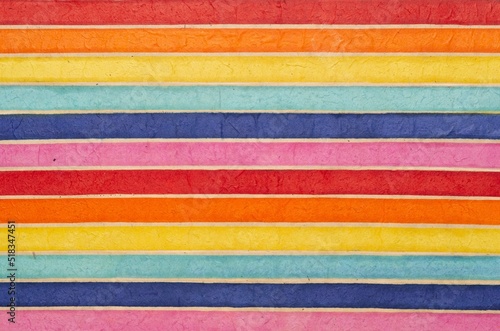 horizontally colored or multi-colored striped pattern background, recycled and organic material. Fiber textured paper. 