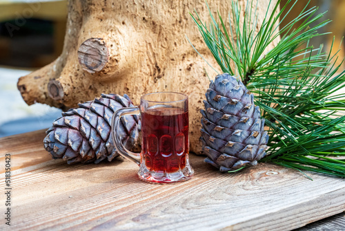 Fototapeta a glass swiss stone pine schnapps, cones and twigs from the swiss stone pine or