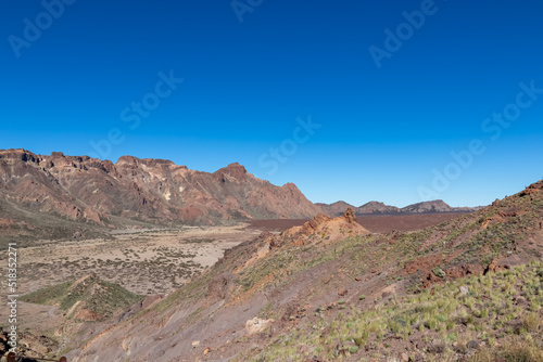 Panoramic view on Roque del Almendro  El Sombrero in volcano Mount Teide National Park  Tenerife  Canary Islands  Spain  Europe. Volcanic barren desert landscape. Scenic hiking trail on sunny day