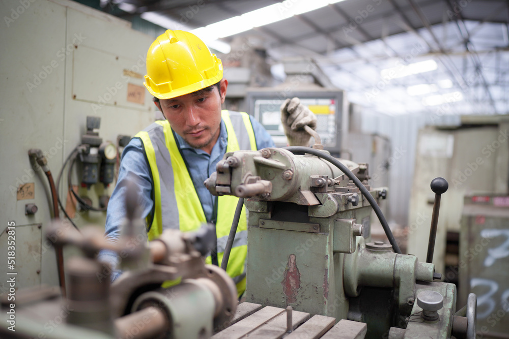 Portrait of a Professional Heavy Industry Engineer Worker Wearing Uniform, Glasses and Hard Hat in a Steel Factory. Industrial Specialist Standing in Metal Construction Facility.