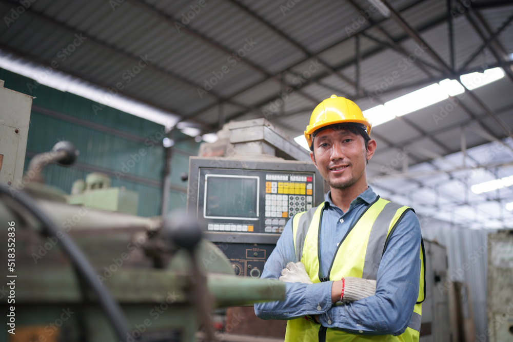 Portrait of a Professional Heavy Industry Engineer Worker Wearing Uniform, Glasses and Hard Hat in a Steel Factory. Industrial Specialist Standing in Metal Construction Facility. Portrait of a Professional Heavy Industry Engineer Worker Wearing Uniform, Glasses and Hard Hat in a Steel Factory. Industrial Specialist Standing in Metal Construction Facility.
