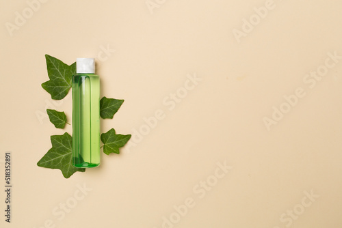 Obraz na płótnie Cosmetic product with ivy extract on color background, top view