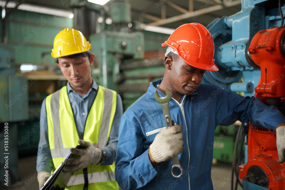 Team maintenance engineers men and women inspect relay protection system with laptop comp. They work a heavy industry manufacturing factory. Team maintenance engineers men and women inspect relay protection system with laptop comp. They work a heavy industry manufacturing factory.