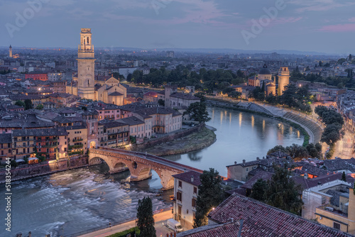 View of Verona historical center from Castel Sanpietro from drone, on the Adige river with its curve that contains the ancient city. Sunset in February 2022, visible stone bridge, the basilica of Vero
