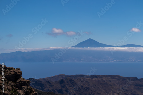 Scenic view on cloud covered volcano mountain peak Pico del Teide on Tenerife seen from Mirador Morro de Agando  La Gomera  Canary Islands  Spain  Europe. Lookout near Roque de Agando. Atlantic Ocean