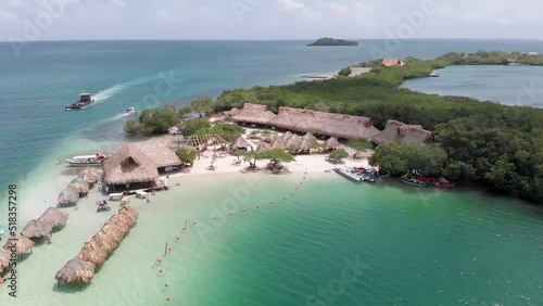 Aerial panoramic view flying over El Cholon island with bungalows and a nice tropical beach, in Baru, Islas del Rosario, Cartagena, Colombia