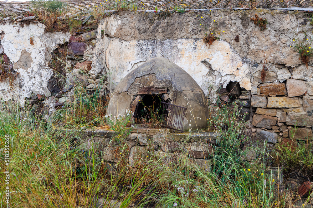 Old dilapidated abandoned house with traditional oven on the island of Sardinia
