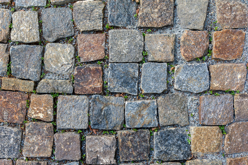 A fragment of an ancient destroyed paving stone in close-up. Texture and pattern of masonry