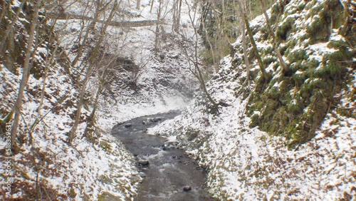 River running through snow forest in  Japan photo