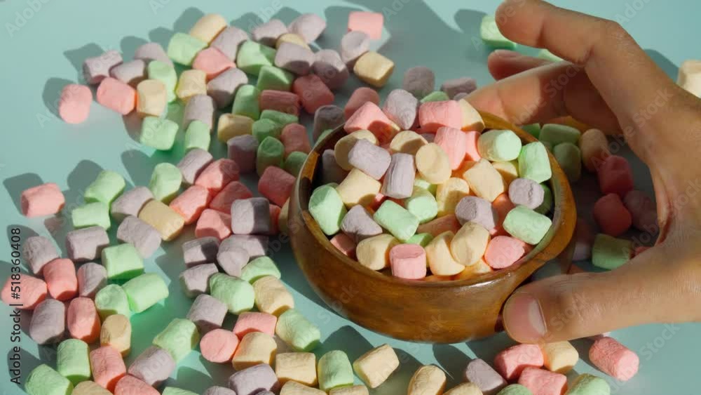 Marshmallows on blue background. Delicate dessert. The concept of winter food. Marshmallows on blue background. Delicate dessert. The concept of winter food.