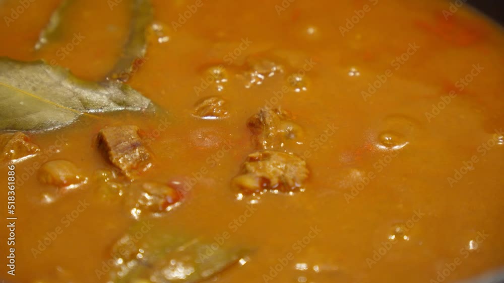 Cooking beef meat in tomato sauce. Selective focus. Cooking hot food at home Cooking beef meat in tomato sauce. Selective focus. Cooking hot food at home