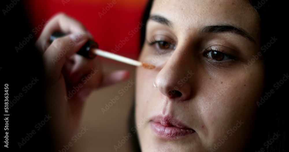 Applying make-up to female face