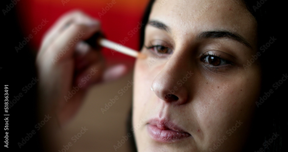 Applying make-up to female face