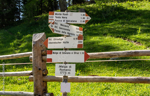 Signpost showing trail directions along mountain path in the Mount Roen - Italian dolomites - northern italy