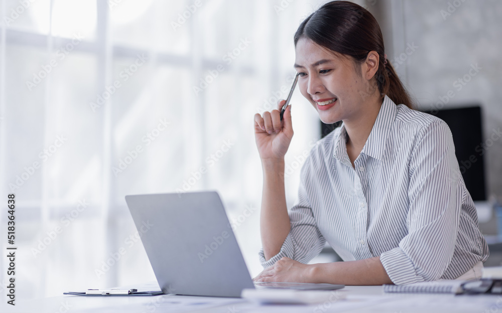 Portrait of Accountant Young Asian female working on a laptop, doing calculator planning analyzing the financial report, business plan investment, finance analysis concept Portrait of Accountant Young Asian female working on a laptop, doing calculator planning analyzing the financial report, business plan investment, finance analysis concept