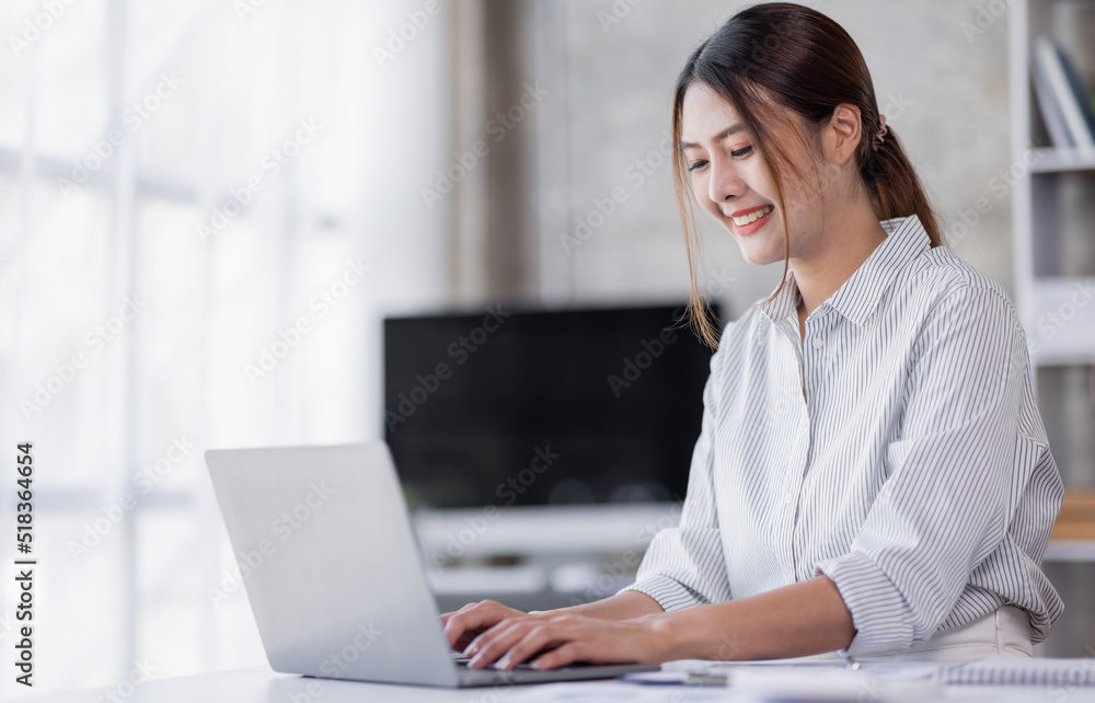 Portrait of Accountant Young Asian female working on a laptop, doing calculator planning analyzing the financial report, business plan investment, finance analysis concept Portrait of Accountant Young Asian female working on a laptop, doing calculator planning analyzing the financial report, business plan investment, finance analysis concept