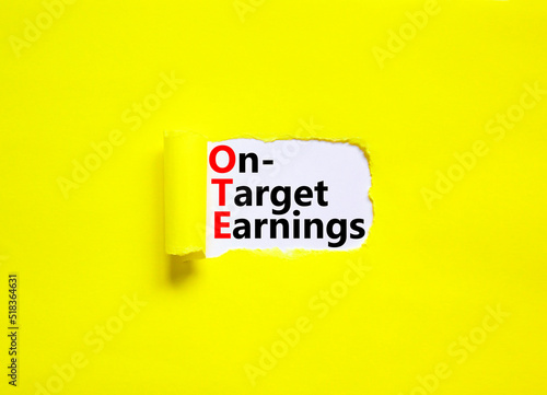 OTE on-target earnings symbol. Concept words OTE on-target earnings on white paper on a beautiful yellow background. Business and OTE on-target earnings concept. Copy space.