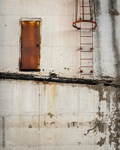 Abstract architecture of rusty ladder and door