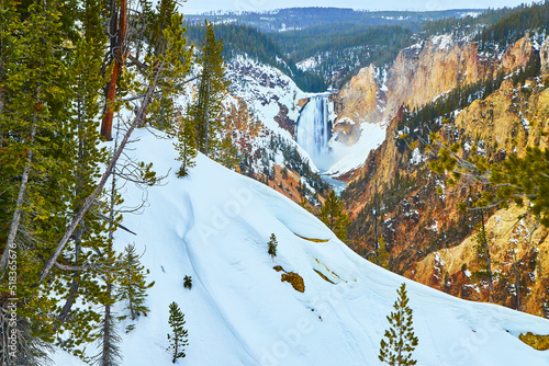 Winter at Yellowstone Upper Falls with huge snowy slopes