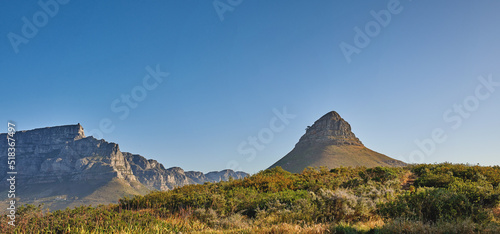 Copy space, landscape view and mountains of Lions Head and Table Mountain in serene, relaxing nature reserve. Blue sky with copyspace in Cape Town, South Africa of tranquil, local countryside scenery