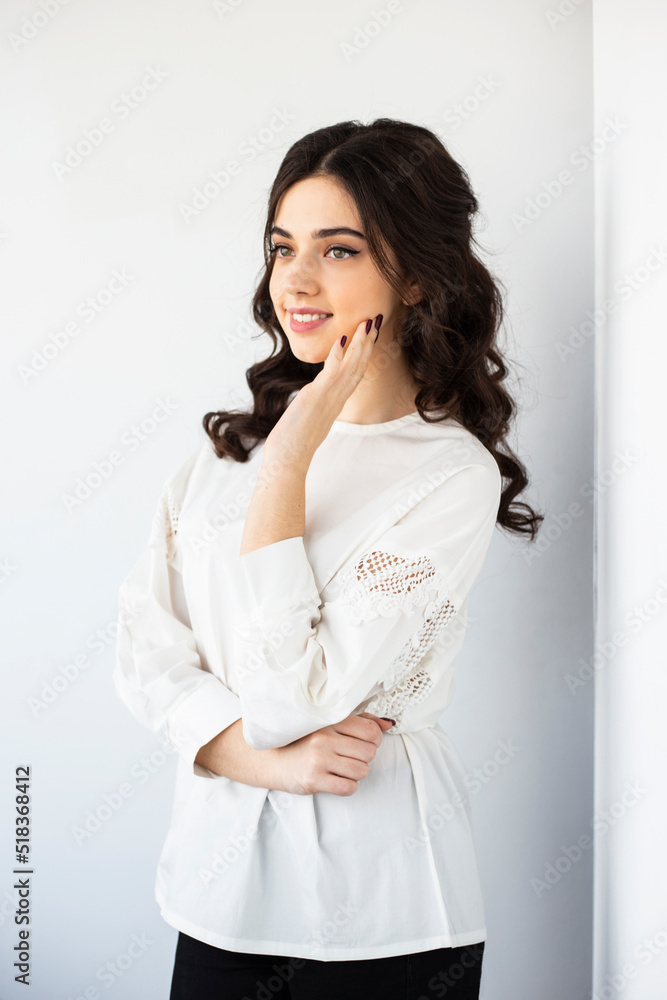 Beauty profile portrait of a cheerful young woman wear white shirt, posing in a studio, isolated white background. Beauty profile portrait of a cheerful young woman wear white shirt, posing in a studio, isolated white background.