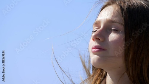 future, hope -girl looks at the sky smiling and close your eyes enjoying the sun