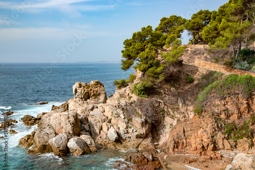 Mediterranean sea with rocky coast in Lloret de Mar located in popular Costa Brava, Catalonia, Spain. Amazing rock cliff seascape in the coastline.