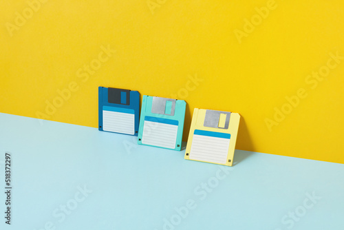 Colored old floppy disks over duotone background
